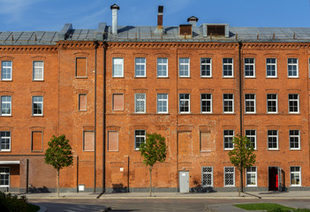 Office building of red brick in the yard of the old factory