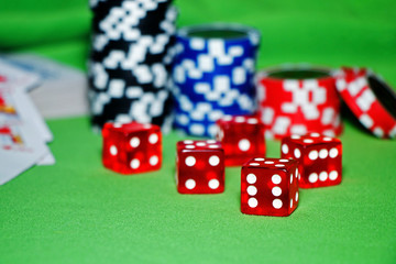 Casino. Playing cards, poker bones, chips on a green velvet table