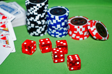 Casino. Playing cards, poker bones, chips on a green velvet table