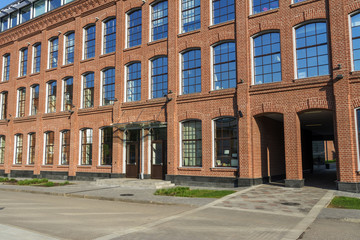 Office building of red brick in the yard of the old factory