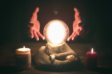 Crystal ball and fortune teller hands. Divination concept. The spiritual seance. Future reading.