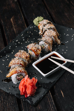 Golden dragon sushi roll with tuna, eel, cucumber, sesame seeds