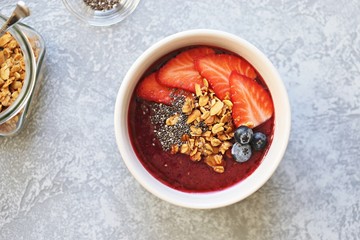 Smoothie bowl. Berrie smothie with chia seeds, granola and blueberry topping. Super food, clean eating,plant based concept. Copy space