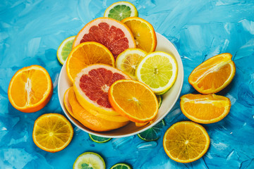 citrus slices with ice on a blue background