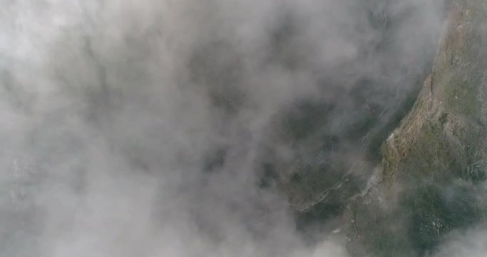 Clouds moving in sky about Kelimutu volcano crater aerial view, Indonesia