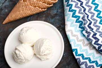 Ice cream balls, scoops and waffle cones on dark background. Advertising space.