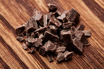 crumbs of black chocolate on a wooden background