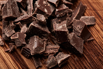 crumbs of black chocolate on a wooden background