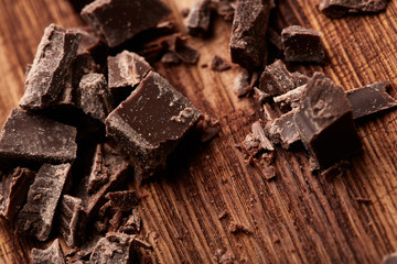 crumbs of black chocolate on a wooden background