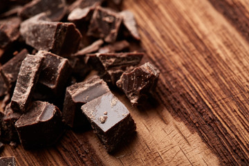 crumbs of black chocolate on a wooden background