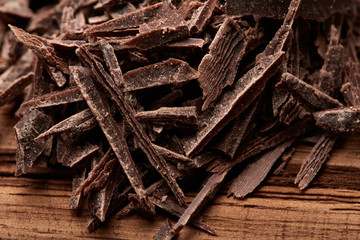 crumbs of black chocolate on a wooden background