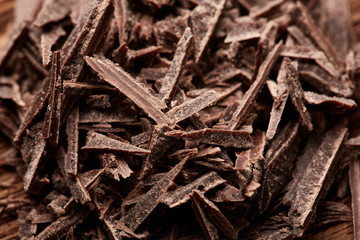 crumbs of black chocolate on a wooden background