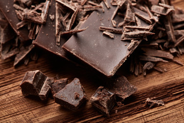 crumbs of black chocolate on a wooden background