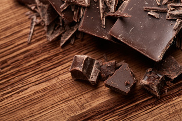 crumbs of black chocolate on a wooden background