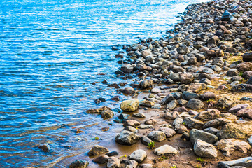 Beautiful sandy and rocky shore of the sea in the evening quiet time