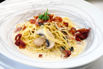 Spaghetti carbonara with grill bacon on white dish