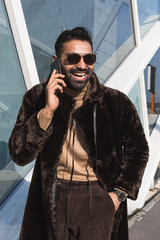 Young Indian man talking on phone