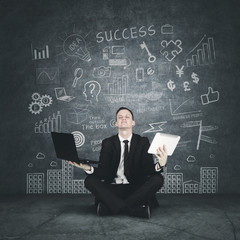 successful businessman in lotus position