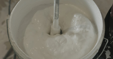 stirring putty in the bucket