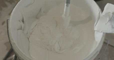 stirring putty in the bucket