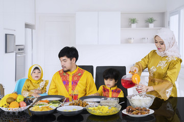 Beautiful woman pouring syrup for her family