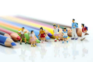 Miniature people : children and student with colorful drawing tools and stationary,education concept.