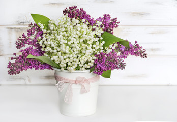 Bouquet of Purple Lilac and Lily of the Valley on a  Wooden Background.Spring Background