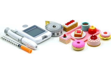 Sweet dessert and Glucose meter diabetes test  and Syringe with measuring tape,concept of diabetes, healthy lifestyles and nutrition.