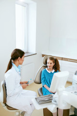 Fototapeta premium Dental Health. Dentist And Happy Girl In Dentistry Office