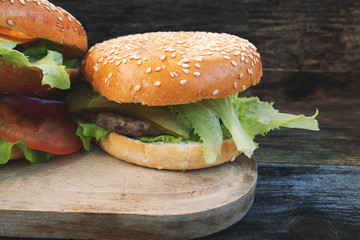 A beautiful homemade hamburger on a rustic wooden background