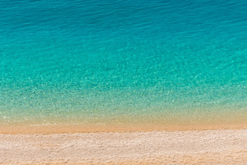 Obraz premium Crystal clear turquoise sea waters of a pebble beach. Porto Katsiki beach in Lefkada ionian island in Greece. 