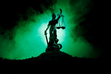 The Statue of Justice - lady justice or Iustitia / Justitia the Roman goddess of Justice on a dark fire background