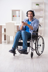 Fototapeta na wymiar Disabled man listening to music in wheelchair