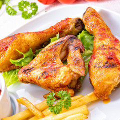 Grilled chicken wings,legs,chips and vegetables