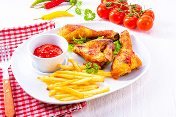 Grilled chicken wings,legs,chips and vegetables