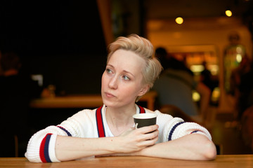 girl drinking coffee in a cafe