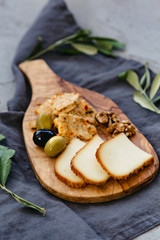 Cheese board with olives and walnut.