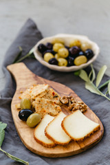 Cheese board with olives and walnut.