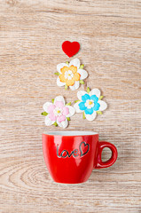colorful artificial flower with red cup.