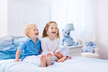 Kids playing in white bedroom