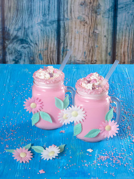 Pink unicorn milk shake with whipped cream, sugar and sprinkles