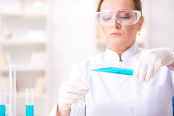 Woman chemist working in hospital clinic lab