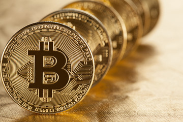 Bitcoins on golden background