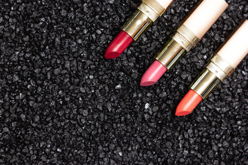 Trendy lip make-up background - lipstick on anthracite surface