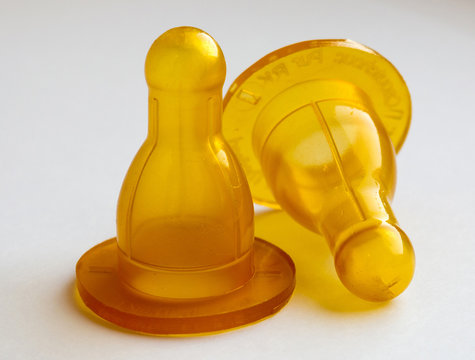 two large latex nipples for baby bottles