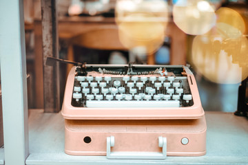 Old fashioned, retro typewriter close up photo. Sun flares filter effect