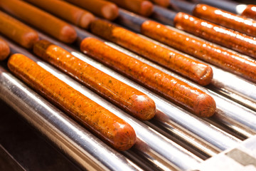 Automatic electric grill with sausages. For cooking. Can be used show how delicious appetizers are prepared and hot dogs.