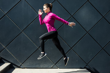 City sport. Fitness sport girl in sportswear doing fitness exercise in the street, outdoor sports, urban style