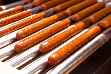 Automatic electric grill with sausages. For cooking. Can be used show how delicious appetizers are prepared and hot dogs.