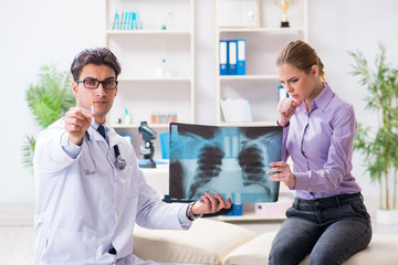 Fototapeta premium Doctor examining x-ray images of patient